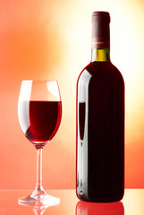 Glass and bottle of red wine.