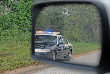 Police in rear view mirror