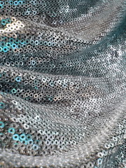 Silver blue sequined textile closeup. Disco, christmas design