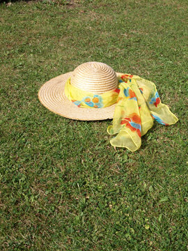 Straw hat with bright scarf