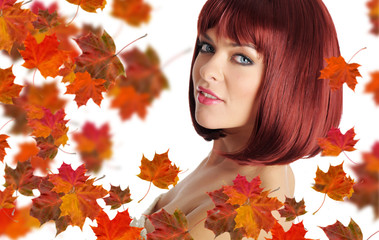 Naklejka na ściany i meble Beautiful young woman with red hair and maple leaves
