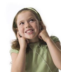 Young girl smiling listening to earphones on white background