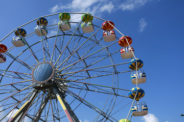A colorful big fun wheel against blue sky