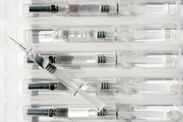 close-up of needles and syringes in a package