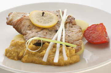 carp fillet on organic potato and lemon