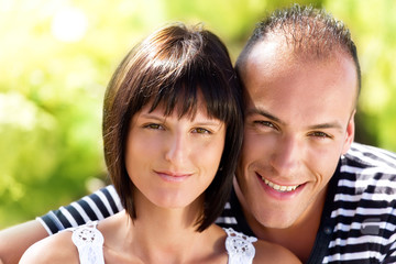 Fototapeta premium Close-up portrait of young happy couple in the nature.