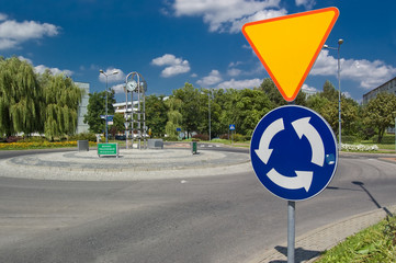 Roundabout with a clock and sign before - 16577851