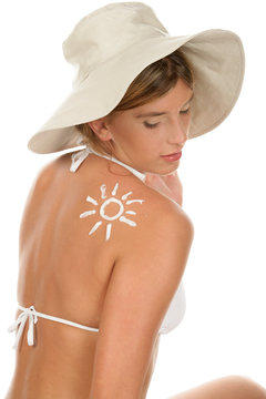 Portrait of young woman with suntan lotion
