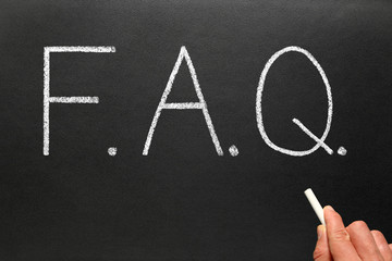 FAQ, frequently asked questions, written on a blackboard.
