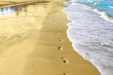 Footprints and reflection on the sand tropical beach