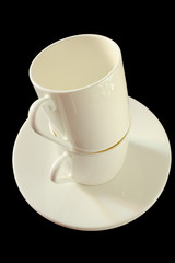 Two cups for espresso coffe, isolated on black