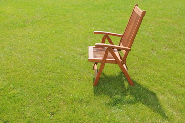 wooden chair in a green lawn
