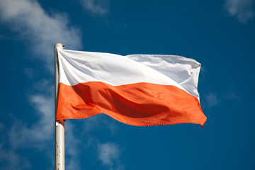 Polish flag against blue sky