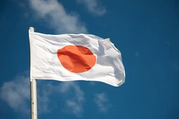 Gardinen Japanese flag against blue sky © Kristina Afanasyeva
