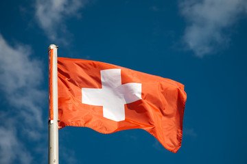Swiss flag against blue sky