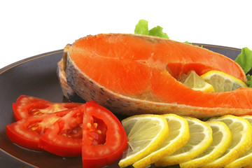 two salmon steak on dark dish