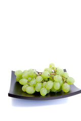bunch of green grapes on a platter
