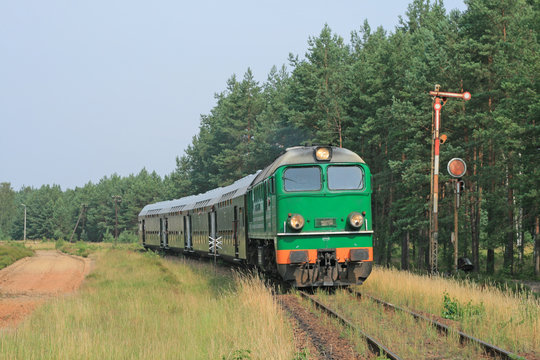 Fototapeta Passenger train passing through polish countryside