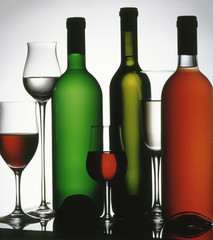Three wine bottle and several glasses