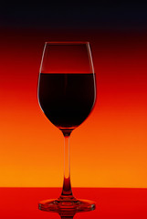 Red wine glass on a bright background