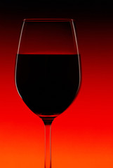 Red wine glass on a bright background