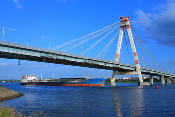 Fototapeta na wymiar oil tanker under the cable-stayed bridge