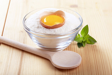 Egg yolk in a bowl of flour