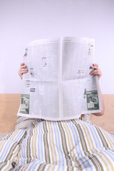 Reading newspaper in bed (flipped version)