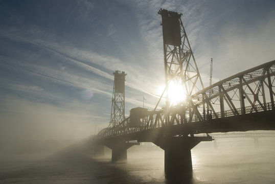 Hawthorne Bridge in Portland with fog and sun.