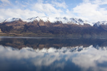 Mountains reflected in still lake