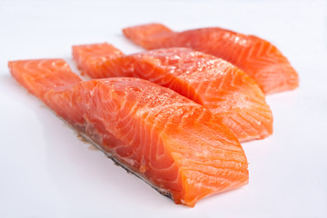 three salmon pieces on white background
