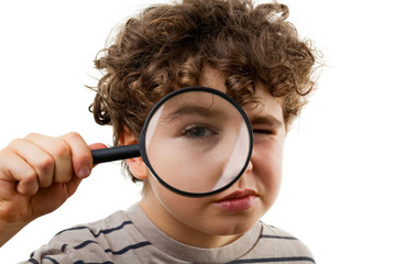 Boy holding magnifying glass isolated on white background
