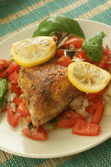 chicken with organic tomato salad on a plate