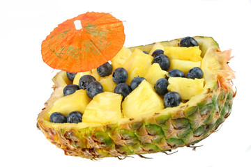 One half of pineapple filled with pineapple cubes and fresh blue