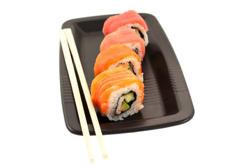 four rolls on a black plate