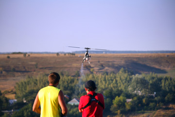 Two guys compete on radio controlled helicopter © Davydov