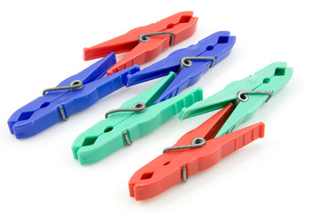 Colorful plastic clothespins over white backgound