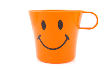Funny orange drinking cup over white backgound