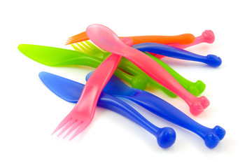 Colorful plastic cutlery over white background