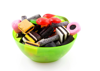 Bowl with candy over white backgound