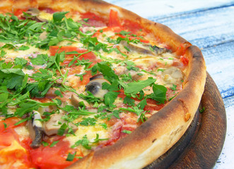 Pizza with salami and vegetables