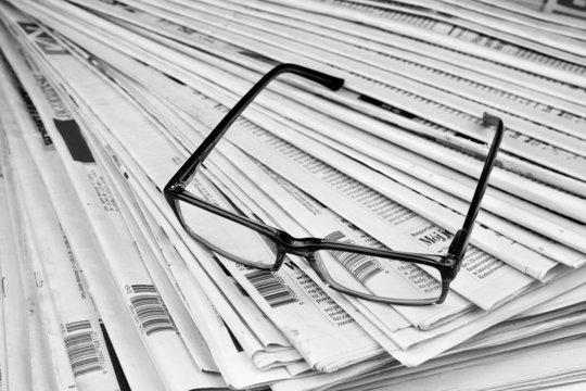 Black and white newspaper and glasses