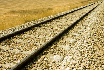 Railroad tracks curving off into the rural fields