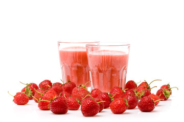 A glass of strawberry smoothie surrounded by fresh berries