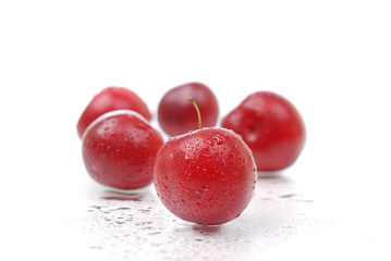 Ripe and juicy plums on white