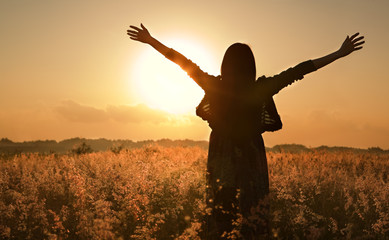 Woman silhouette waiting for summer sun