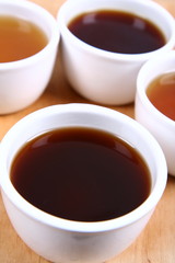 Four white bowls of green, red, black and white tea