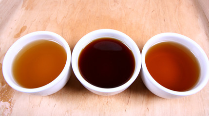 Three white bowls of green, red and white tea