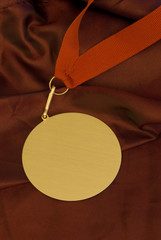 Gold medal on red fabric