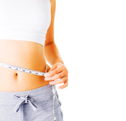 Young Woman Measuring Herself On White